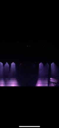 an image of a stage with purple lights on it