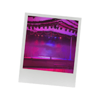 a polaroid photo of a stage with lights